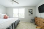 Cozy guest bedroom with queen size bed, dual nightstands and lamps